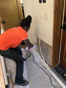 A Technician Removing Water Damage on Sheetrock